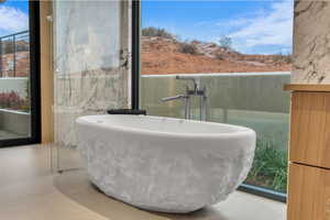 Bathroom with a freestanding tub and a sink