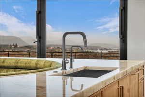 Kitchen view of light stone countertops and light brown cabinetry