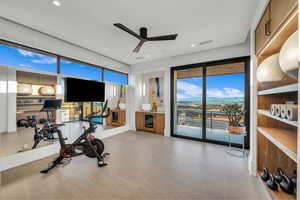Workout area with a ceiling fan, plenty of natural light, and recessed lighting