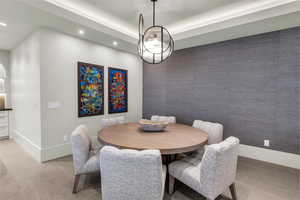Dining area with recessed lighting and light carpet