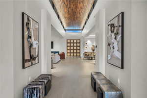 Hallway featuring high vaulted ceiling and brick ceiling