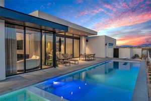 View of pool with a patio and a diving board