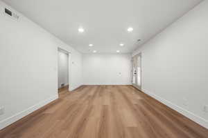 Empty room with light hardwood / wood-style flooring