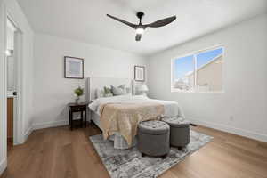 Bedroom featuring ceiling fan, wood-type flooring, and a textured ceiling