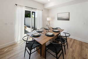 Dining area with light hardwood / wood-style flooring