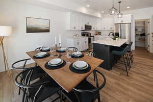 Dining space featuring sink and light hardwood / wood-style flooring