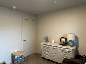 Miscellaneous room featuring dark colored carpet