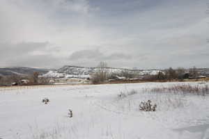 Snowy landscape with a mountain view and fenced for Livestock