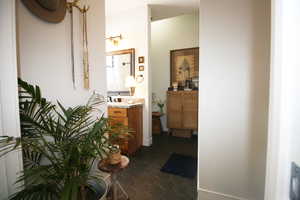 Main Bathroom Entry from Main Bedroom with tile flooring and vanity