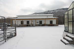 Snow covered property with a mountain view