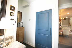 Interior space of Bathroom, Laundry Room, Open to Kitchen with a chandelier