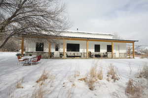 View of snow covered rear of property