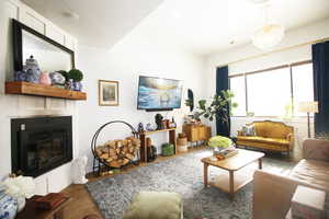 Living room featuring a textured ceiling, dark wood-tile flooring, and a chandelier