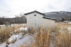 Snowy landscape with a mountain view and Well House