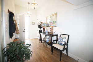 Hallway with a chandelier and wood-type flooring