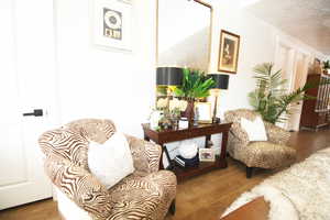 Sitting room with a textured ceiling and wood-tile floors