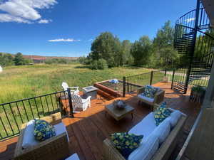 Wooden terrace featuring an outdoor living space with a fire pit