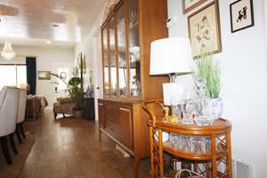 Hall with a textured ceiling and wood-tile floors