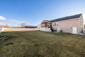 Rear view of property featuring a lawn