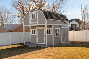 View of outdoor structure featuring a yard