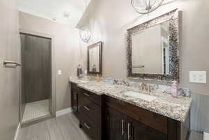 Bathroom with vanity and a tile shower