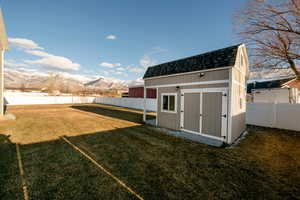 View of outdoor structure featuring a yard and a mountain view