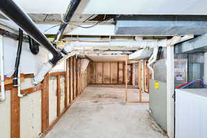 Basement featuring heating unit and washer / dryer