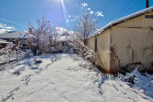 View of yard covered in snow