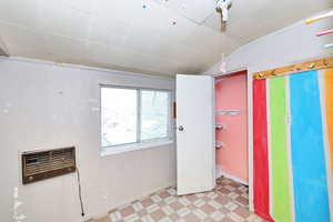 Interior space with lofted ceiling and a wall mounted AC