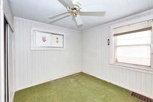 Carpeted empty room with ornamental molding and ceiling fan