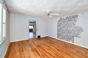 Empty room featuring ceiling fan and light hardwood / wood-style floors