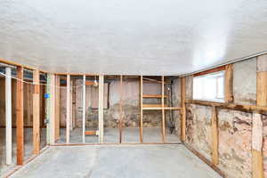 Basement featuring a textured ceiling