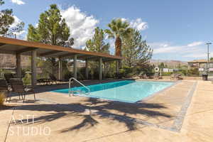 View of pool with a mountain view and a patio area