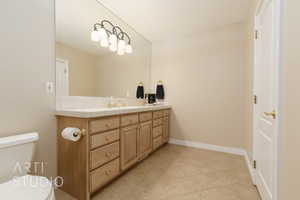 Bathroom with vanity, tile patterned flooring, and toilet