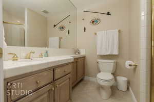 Bathroom with tile patterned flooring, vanity, an enclosed shower, and toilet