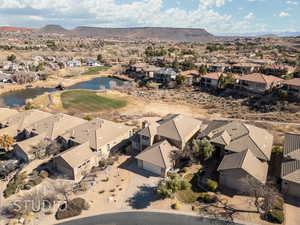 Birds eye view of property featuring a water and mountain view