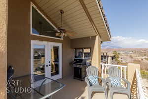 Balcony with a mountain view, a grill, ceiling fan, and french doors