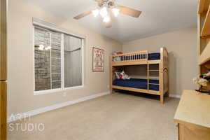 Bedroom with a textured ceiling, light colored carpet, and ceiling fan