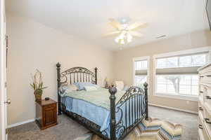 Bedroom with light colored carpet and ceiling fan