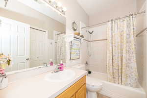 Full bathroom with vanity, toilet, and shower / tub combo