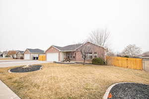 Ranch-style home with a garage and a front yard