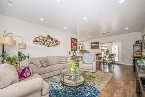 Living room with dark wood-type flooring