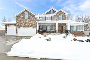 View of front of property featuring a garage and a porch