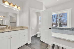 Bathroom featuring toilet, hardwood / wood-style flooring, a bathtub, and vanity