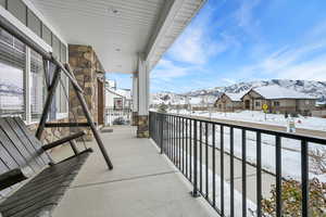 Snow covered back of property with a mountain view