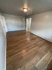 Unit 2 living room with dark hardwood / wood-style flooring