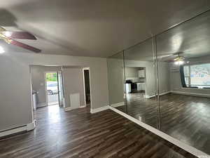 Unit 3 Family room with a baseboard radiator, ceiling fan, and dark hardwood / wood-style flooring