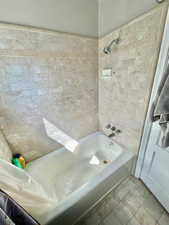 Unit 4 Bathroom featuring tile patterned flooring and tiled shower / bath