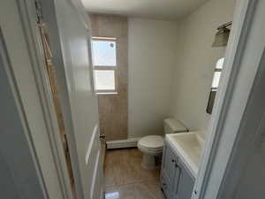 Unit 1Bathroom featuring toilet, a shower, a baseboard radiator, vanity, and tile patterned flooring