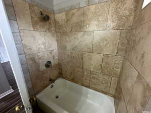 Unit 1 Bathroom with tiled shower / bath combo